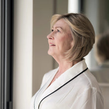 Load image into Gallery viewer, side view of mature woman wearing the "Bella" wig by La Vida Wigs