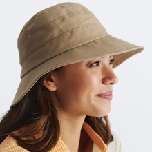 Load image into Gallery viewer, Woman wearing a beige bucket hat on a plain background
