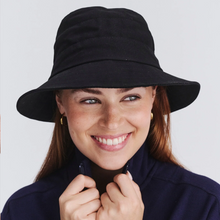 Load image into Gallery viewer, Woman wearing a black bucket hat against a plain background