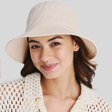 Load image into Gallery viewer, Woman wearing a beige bucket hat against a plain background