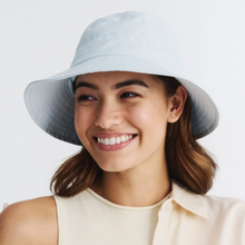 Load image into Gallery viewer, Woman wearing a light blue bucket hat against a white background