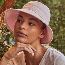 Load image into Gallery viewer, Woman wearing a pink sun hat with a blurred natural background